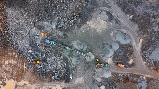 Construction site with vehicles. Heavy machinery works on a construction site. Trucks and equipment move materials and reshape the land during the day.