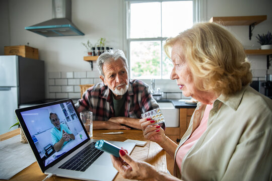 Senior couple consulting doctor online at home