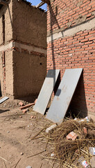 Obraz premium Everyday Rural Architecture with Dirt Ground and Metal Sheets