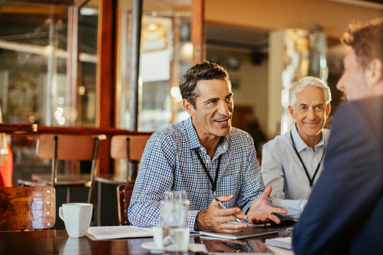 Business professionals discussing project at cafe