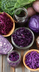 Variety of purple fermented cabbage with raw kale arranged on a wood table, promoting healthy food and probiotic nutrition