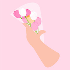 A woman's hand holds a bouquet of pink and white tulips for Mother's Day