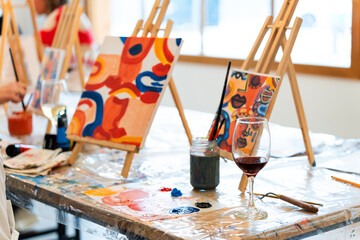 Friends attending a paint and sip art workshop