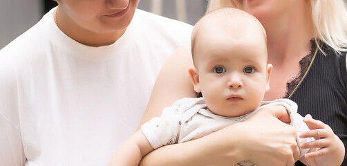 Lesbian interracial family. Two moms with their baby. unconventional family