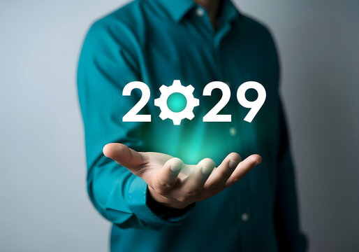 A person holding the year two thousand twenty nine with a gear in their hand with green glow