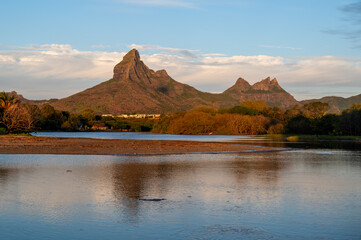 Scenic view of Rempart Mountain reflecting in a calm river at sunset in Tamarin, Mauritius
