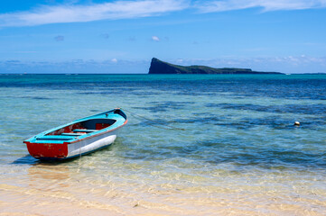 Scenic view of Coin de Mire island across the turquoise ocean from Grand Baie beach in Mauritius