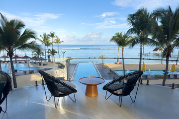 Luxury resort balcony view over an infinity pool and tropical beach in Triolet, Mauritius