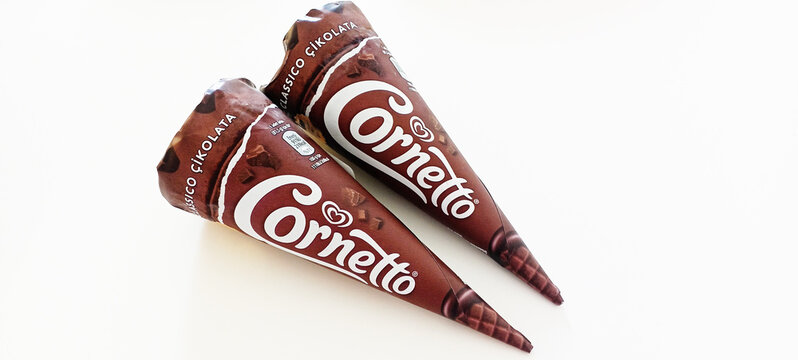 Delicious chocolate cornetto ice cream in a waffle cone with chocolate splashes 