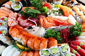 Party tray with sashimi, sushi and maki rolls, shallow focus © Igor S.