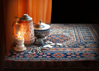 Still life with candle, keys and coins