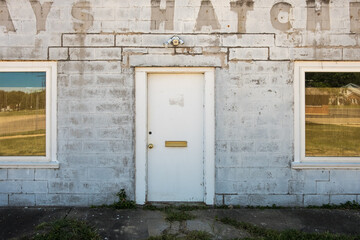 faded letters on the side of a cinder block building