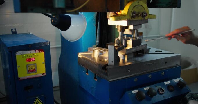 Stamping press mold shaping metal parts, factory machinery operating during mass production at industrial plant
