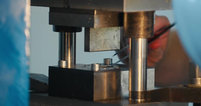 Stamping press mold shaping metal detail during factory production cycle. Manufacturing industry and physical work