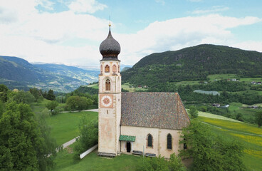 Fototapeta premium Historic Church with Onion Dome in Scenic Alpine Valley Landscape