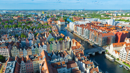 Obraz premium Aerial view of Gdansk Old Town with Motlawa River, colorful historic townhouses, medieval architecture and waterfront skyline