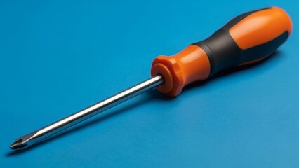 Screwdriver with orange handle on blue.