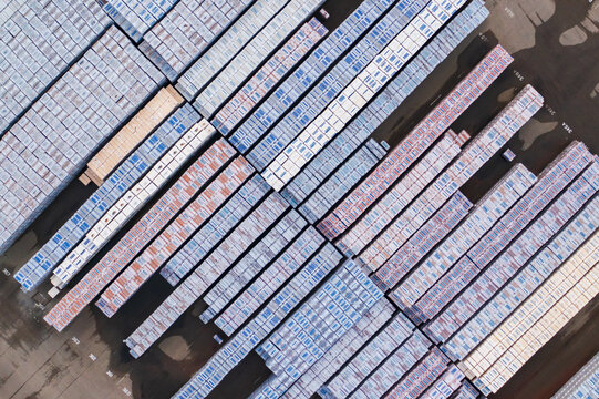 Aerial view of stacks of timber with varying shades and patterns creating an abstract art piece, Gendt, Gelderland, Netherlands.