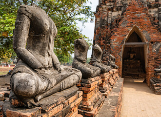 Ayutthaya, Thailand &ndash; Row of decapitated Buddha statues at the Buddhist temple Wat Chaiwatthanaram in the historic city park of Ayutthaya.