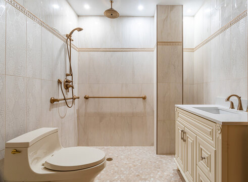 Walk in shower bathroom interior with grab bars, tiled walls, vanity sink and accessible design