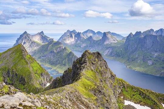 Mountain landscape with steep rocky peaks fjords and sea, view from the top of Munken to Reinefjorden, Moskenes&oslash;ya, Lofoten, Nordland, Norway