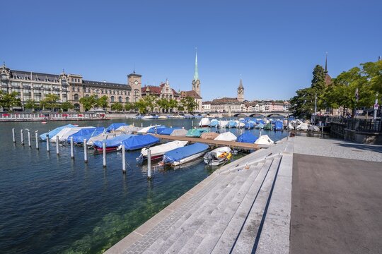Boats at the jetty in the Limmat, towers of the Fraum&uuml;nster and St. Peter, Old Town, Zurich, Switzerland