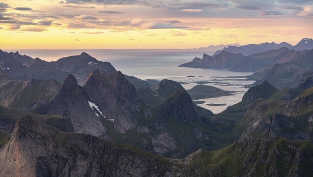 View over mountain tops and sea to Fredvang, dramatic sunset, from Hermannsdalstinden, Moskenes&ouml;y, Lofoten, Nordland, Norway