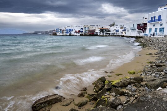 Long exposure beach, White Cycladic houses on the shore, Little Venice, dramatic dark clouds Chora, Mykonos Town, Mykonos, Cyclades, Aegean Sea, Greece