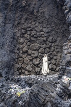 Statue of the Virgin Mary on a rock, Praia da Ribeira da Janel, Madeira, Portugal
