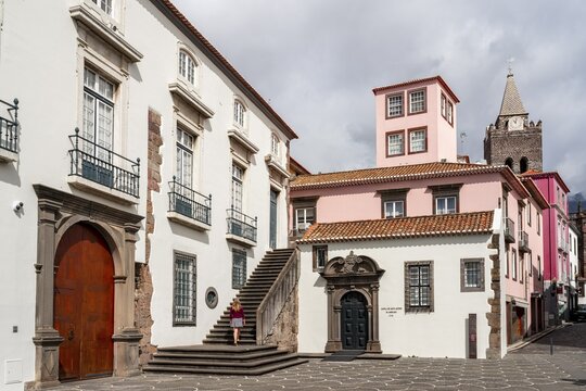 Small square in the old town with colourful houses and chapel Capela de Santo Antonio de Mouraria, tower of the church S&eacute; do Funchal in the back, Funchal, Madeira, Portugal