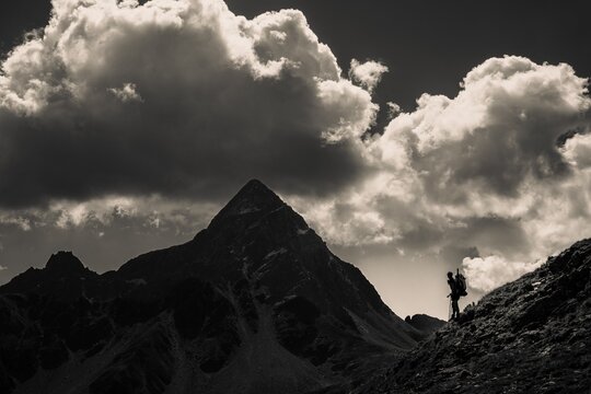 Striking peak of Piz OT with climber in the backlight, St Moritz, Engadin, Grisons, Switzerland
