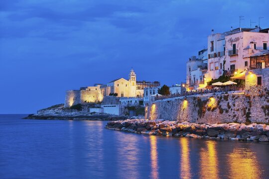 Punta San Francesco with illuminated church of San Francesco and old town at blue hour, Vieste, Gargano, Foggia, Apulia, Puglia, Southern Italy, Italy