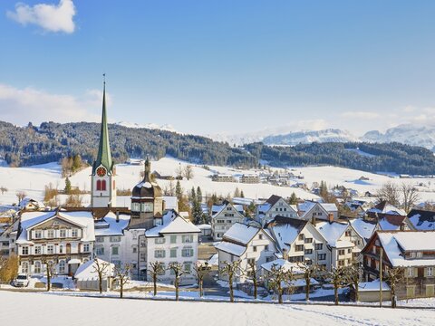 Snow-covered village view with typical Appenzell houses facing south with the Reformed church in the back, Gais, Appenzell Ausserrhoden, Switzerland