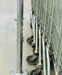 Neatly Organized Supermarket Carts Under Bright Retail Lighting. Efficiently Arranged Shopping Carts On Concrete Floor Under Fluorescent Fixtures Creating Clean Shopping Environment