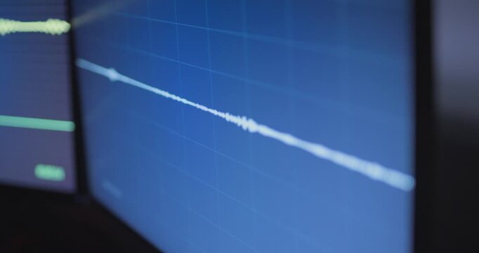 Close up on computer screen during audio recording or wiretapping investigation. Police or detective spy listening to conversation remotely. Editing sound on device. Dark room agency spying on people