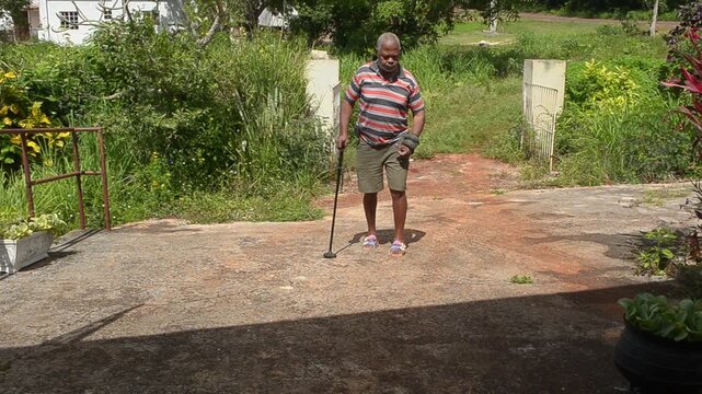 Walking Up The Walkway With A Walking Stick
