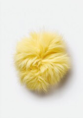 Fluffy yellow sphere on a plain white background, appearing soft and inviting