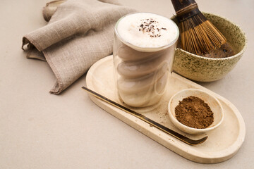 Hojicha latte drink with tea ceremony whisk and powder