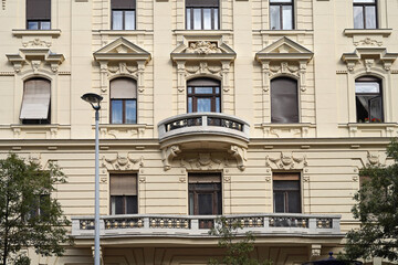Obraz premium Facade of ornate old apartment bulding with large and small balcony