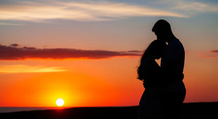 Obraz premium Silhouette of a couple embracing against a dramatic sunset sky. Emotional scene representing love, commitment, intimacy, and shared moments at the end of the day.