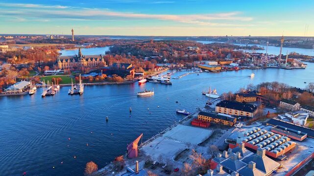 Nordic Museum and Djurgarden bay in Stockholm. Wide aerial view of the Nordic Museum building and waterfront with boats at sunset.