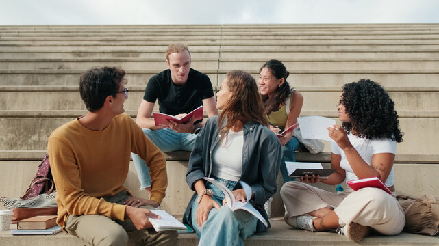 Group Of Students Studying Outdoors On Steps