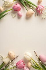 Naklejka premium Pastel vertical eggs and tulip create a Happy Easter celebration feel with a soft beige background. This floral arrangement conveys greeting, warmth, and springtime mood for seasonal imagery