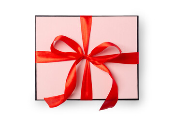 Pastel pink gift box with red ribbon isolated on white background, top view