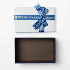 Open gift box with blue ribbon on a white background, top view