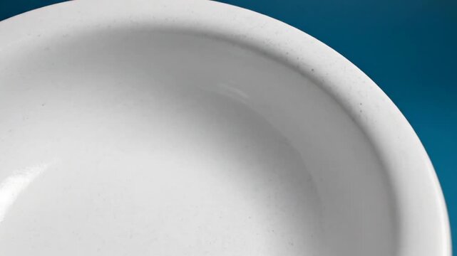 White Porcelain Evaporating Dish with Spout on Blue Background, Laboratory Equipment for Chemical Experiments.