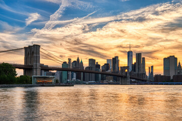 Fototapeta premium New York City Manhattan Downtown with Brooklyn Bridge at Sunset