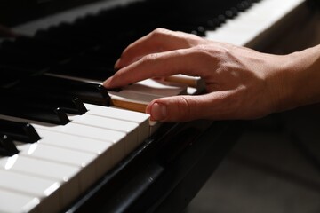 Obraz premium Musician playing piano indoors, closeup. Musical instrument