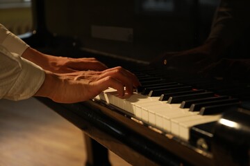 Obraz premium Musician playing piano indoors, closeup. Musical instrument