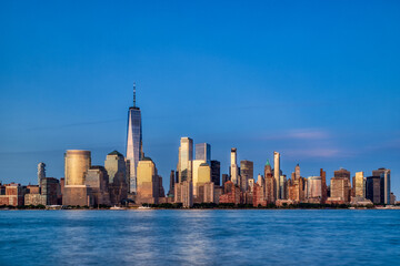 Fototapeta premium Illuminated New York City Skyline View at Dusk, New York